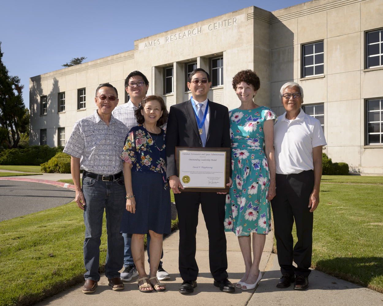 David Thipphavong and family pose with his award.