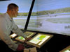 Photo of a FutureFlight staffer, standing in for a Kennedy controller, observing the virtual shuttle landing